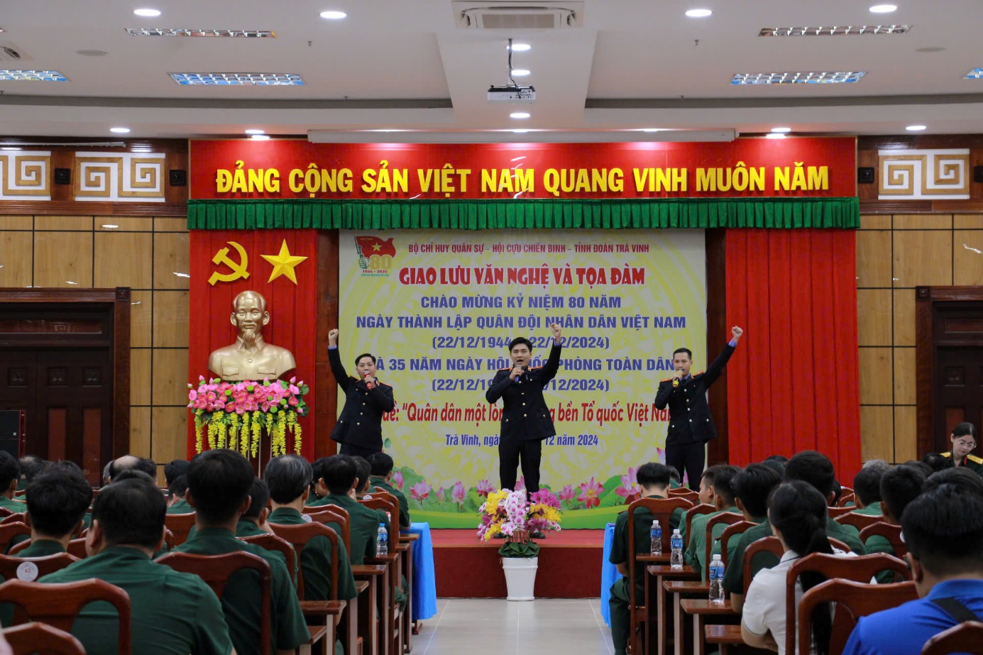 A group of people in uniform on a stage

Description automatically generated